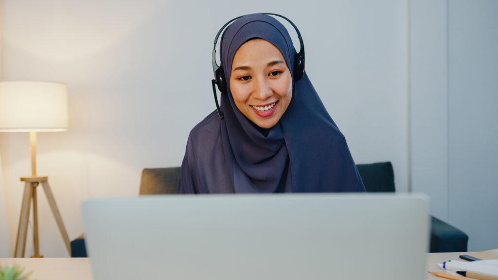 Asia muslim lady wear headphone watch webinar listen online cour